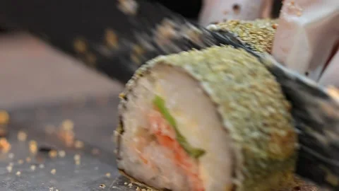 Chef slicing sushi roll with sharp knife Stock Footage 289614475