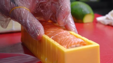 Chef slicing sushi using sushi mold on table in restaurant, copy space Stock Footage 269547058