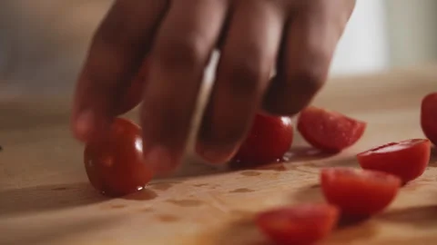 Chef slicing tomatoes on a cutting board Stock Footage 274672317