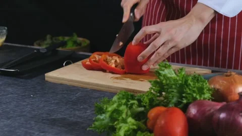 Chef slicing tomatoes to prepare them for cooking. Stock Footage 147088634