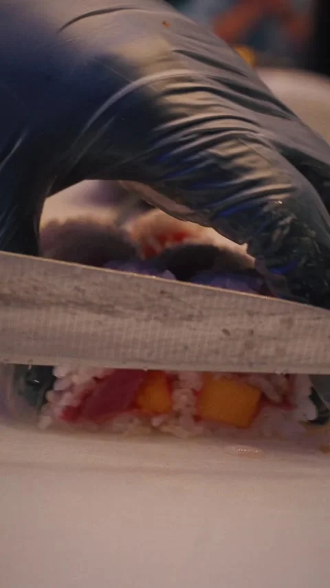Chef slicing tuna mango rice sheet sushi roll – 4K vertical video Stock Footage 315565035
