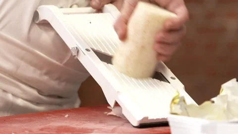 Chef slicing vegetable with mandolin slicer Stock Footage 92071219
