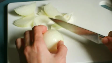 Chef slicing white onion on cutting board Video stock 311943094