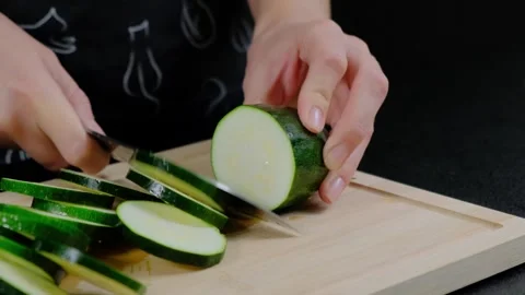 Chef Slicing Zucchini on Cutting Board Cooking Stock Footage 341419480