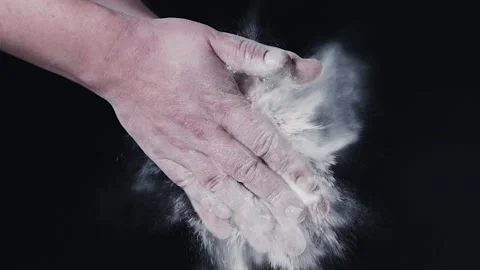 The chef is slowly clapping his hands in flour. Stock Footage 140182391