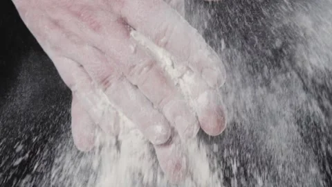 The chef is slowly clapping his hands in flour. Stock Footage 140247149