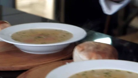 Chef smears bread with butter to serve them with soup Video stock 83677881