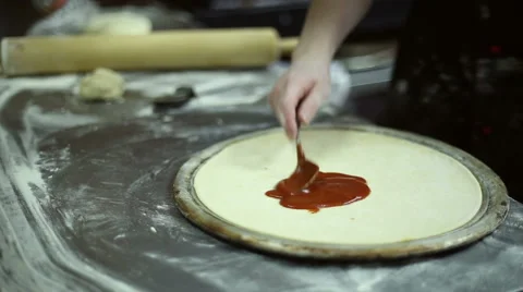 The chef smears ketchup on the dough Stock Footage 59700178