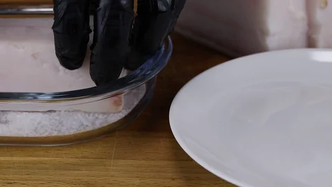 The chef soaks in salt a large piece of pork fat Stock Footage 121784471