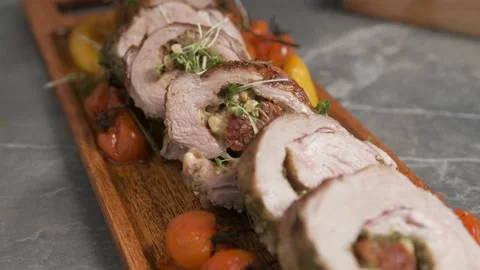 Chef spices the cooked pork with vegetables. Stock Footage 144196675