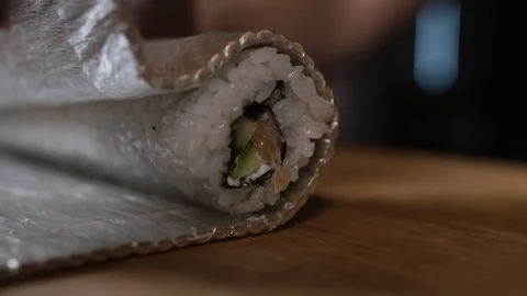Chef spins roll in a bamboo mat Stock Footage 124210478