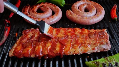 Chef spread sauce pork ribs On Grill. Cooking natural sausage on grill. Stock Footage 274095414