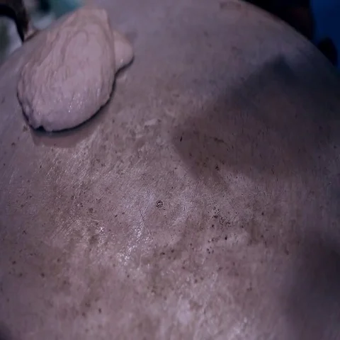 Chef spreading Arabic bread batter on griddle. Stock Footage 69405231