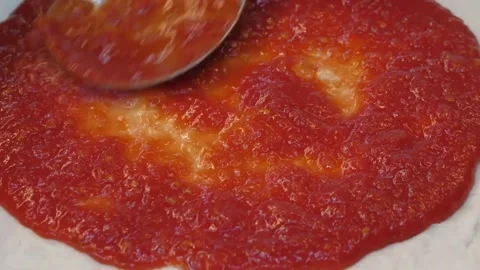 Chef Spreading Authentic Tomato Sauce on Raw Pizza Dough Close-Up Stock Footage 337676619