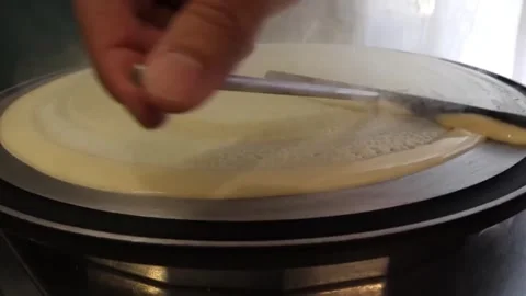 Chef Spreading Batter on Crepe Maker to Bake Fresh Crepes Video stock 345691920