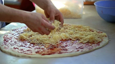 Chef Spreading Cheese Toppings on Pizza Base Stock Footage 101586776