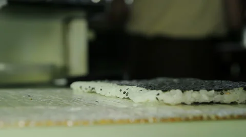 Chef spreading cream cheese over nori Stock Footage 41954872