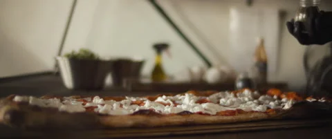 Chef spreading herb spices over a ready burrata al taglio pizza. Close up, sl Stock Footage 146604892