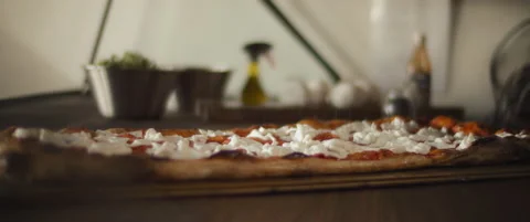 Chef spreading salt over a ready burrata al taglio pizza. Close up, slow moti Stock Footage 146604657