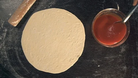 Chef spreading tomato sauce. Making Pizza Stock Footage 74491441
