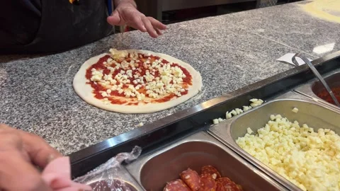 Chef sprinking cheese and meat on pizza. close up putting meat Stock Footage 275147693