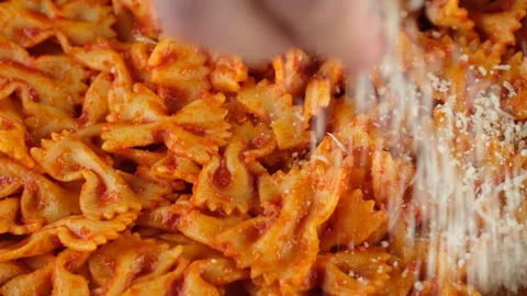 Chef sprinkle grated cheese on pasta. Cooking traditional italian dinner Stock Footage 246535436
