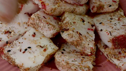 Chef sprinkle piece raw pork lard on pink dish with spices and salt. Stock Footage 234808294