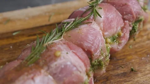 Chef sprinkle spices over a piece of meat with rosemary, prepares the food. Stock Footage 143713358
