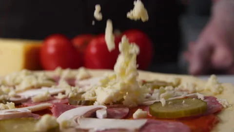 Chef sprinkles cheese on pizza Stock Footage 204717963