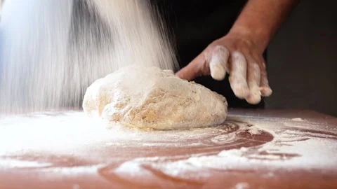 Chef sprinkles dough with flour Stock Footage 113353589