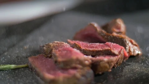 The chef sprinkles a fillet of salt with salt Stock Footage 106924006