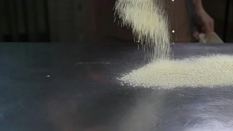 Chef sprinkles flour on desktop Stock Footage 134954713
