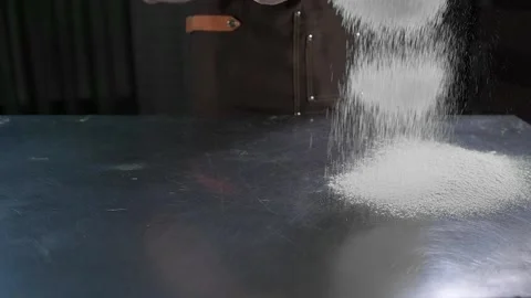 Chef sprinkles flour on desktop Stock Footage 134954716
