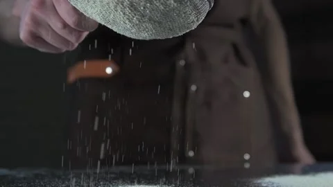 Chef sprinkles flour on desktop Stock Footage 134954768