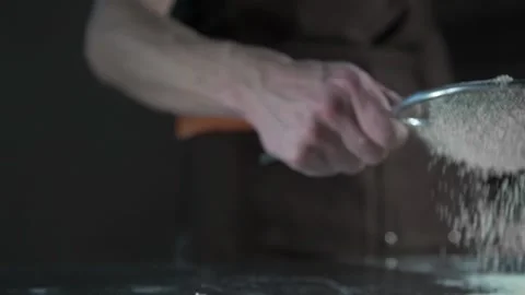 Chef sprinkles flour on desktop Stock-Footage 134954807