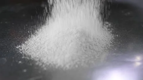 Chef sprinkles flour on desktop Stock-Footage 134954858
