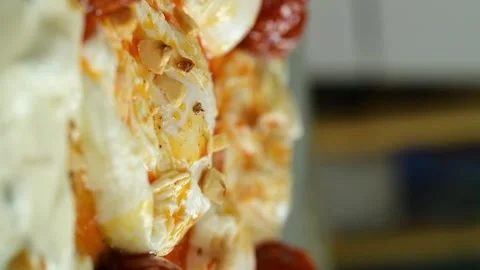 The chef sprinkles hazelnuts on а poached eggs. Vertical video. Stock Footage 311046150