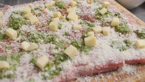 The chef sprinkles peanuts over a piece of fresh meat for dinner. Stock Footage 143588595