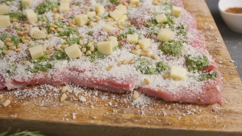 Chef sprinkles peanuts over a piece of fresh meat for dinner. Stock Footage 143921811