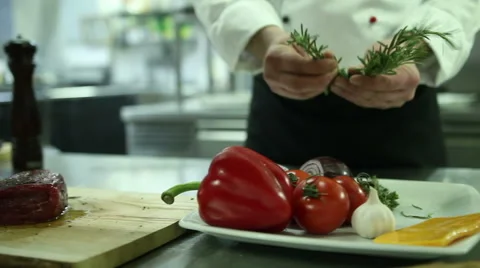 Chef sprinkles spice steak Stock Footage 61851476