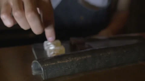 A chef sprinkles a tiny bit of chili on a gourmet dessert or candy Video stock 58758040