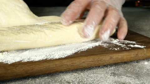 Chef sprinkles wheat flour on kitchen board. Stock Footage 132348758