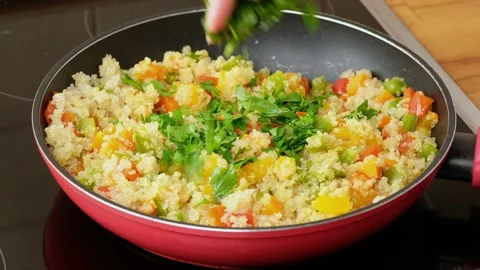Chef sprinkling the dish in a frying pan with fresh chopped parsley.  Stock Footage 254351405