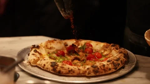 Chef Sprinkling Red Spices on Fresh Neapolitan Style Pizza Stock Footage 341924474