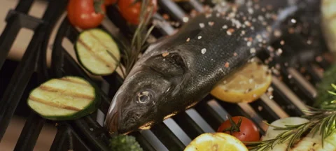 Chef sprinkling spices on fish Stock-Footage 311833678