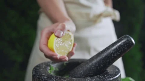 Chef squeezes out lemon juice to the bowl for cooking sauce, fruit juice, making Video stock 77548077