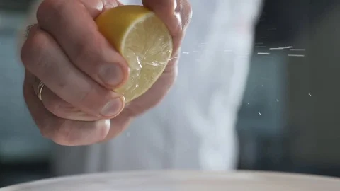 Chef squeezes out the lemon juice in slow motion, 240 frames per second, fruit Stock Footage 81366659