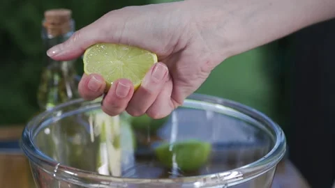 Chef squeezes out lemon juice to the bowl for cooking sauce Stock Footage 143779723