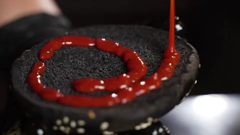 Chef squeezes red sauce Stock Footage 297004146