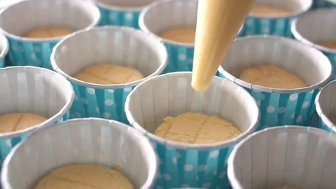 The chef is squeezing the cream cheese on a cupcake blue. Stock Footage 104086051
